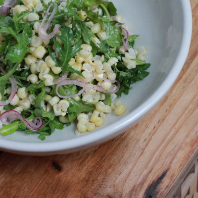 arugula and corn salad with pickled red onions